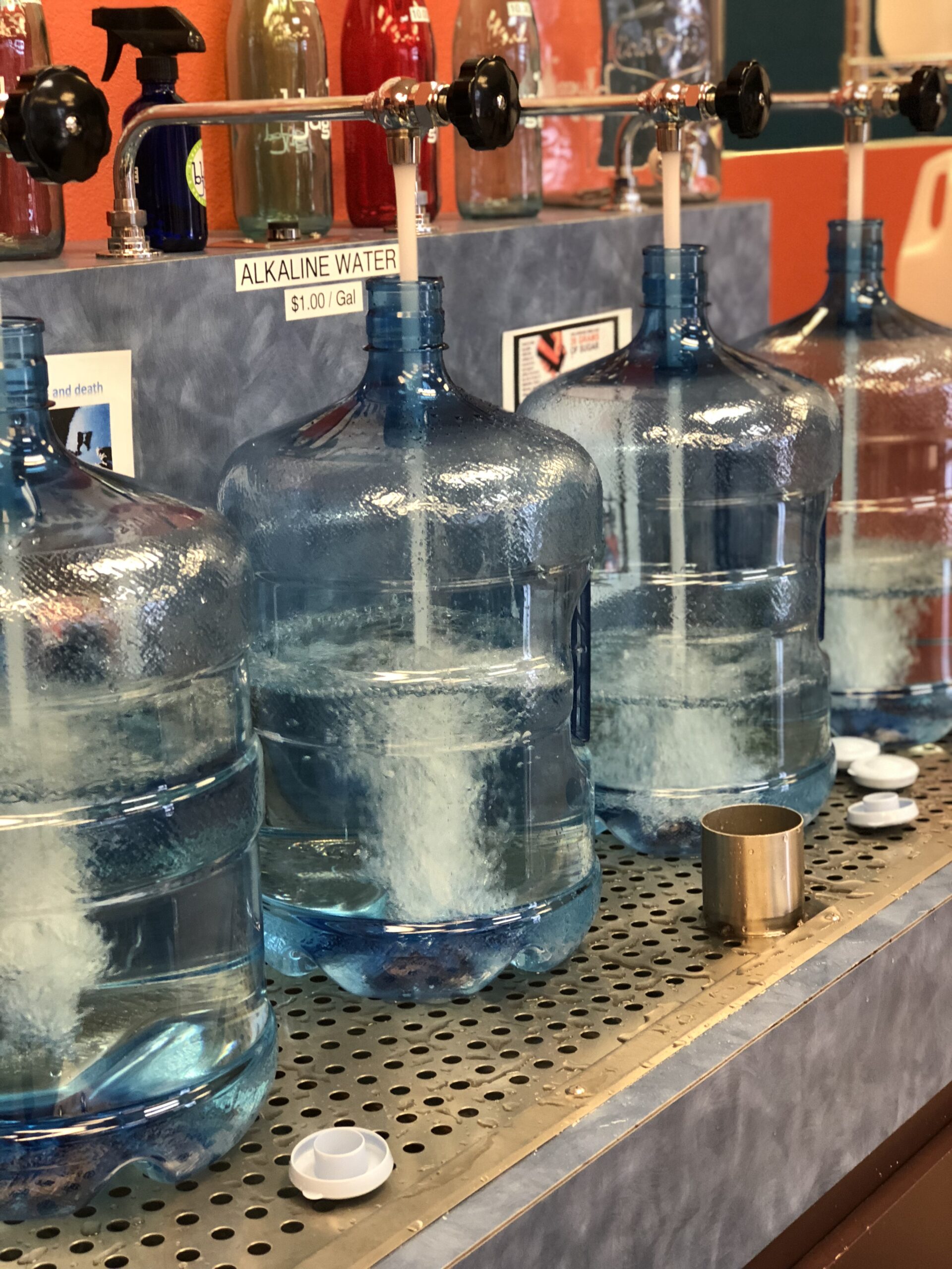 Professional water filtration systems and large glass water crocks for home mineral water storage.